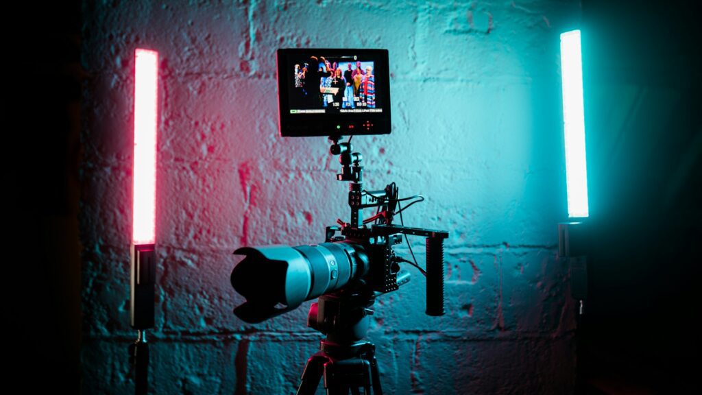 A camera in front of a wall recording a video